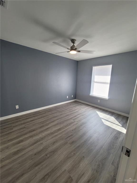 empty room featuring dark hardwood / wood-style floors and ceiling fan