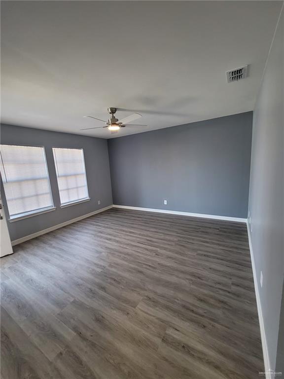 spare room featuring dark hardwood / wood-style flooring and ceiling fan