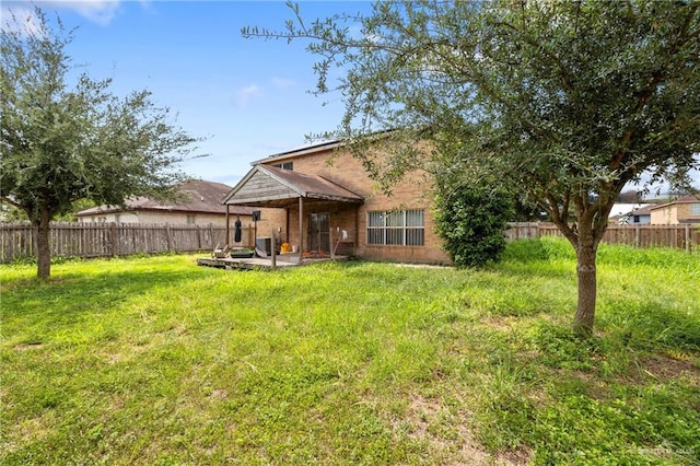 1729 W Jefferson St, Weslaco, TX 78599 - rear view of property with a fenced backyard, brick siding, and a patio area