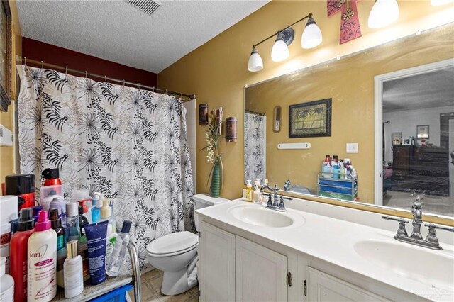 1729 W Jefferson St, Weslaco, TX 78599 - full bathroom featuring double vanity, a textured ceiling, and a shower with shower curtain
