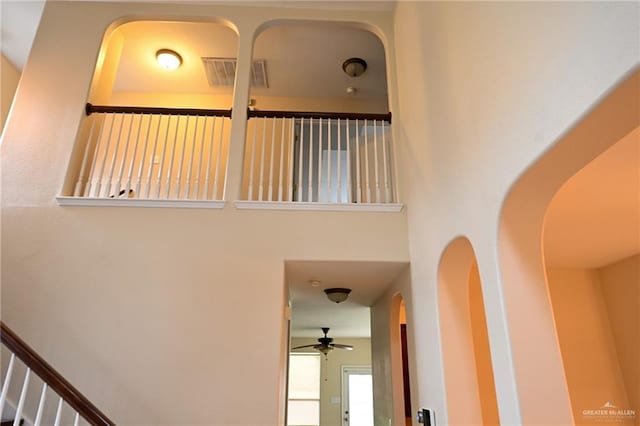 2316 Fairmont Ave, Mcallen, TX 78504 - stairs featuring a ceiling fan, arched walkways, and a high ceiling
