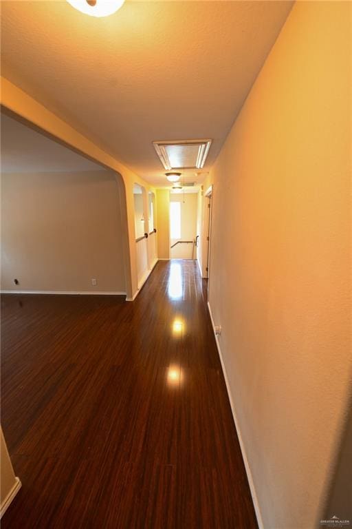 corridor with dark hardwood / wood-style flooring