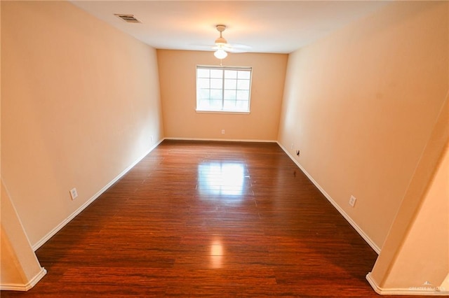 unfurnished room with ceiling fan and dark hardwood / wood-style floors