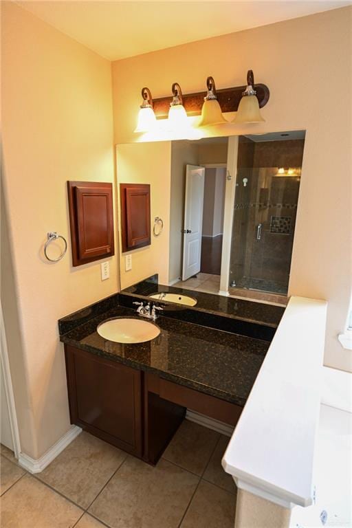 bathroom featuring tile patterned flooring, vanity, and an enclosed shower