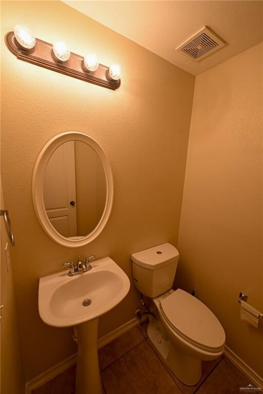 bathroom featuring toilet and tile patterned floors