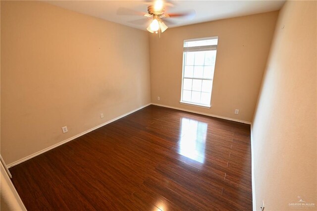 spare room with dark hardwood / wood-style floors and ceiling fan