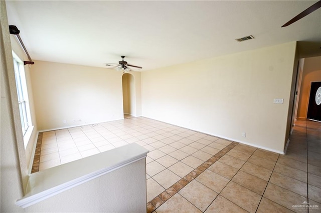 spare room featuring light tile patterned floors and ceiling fan