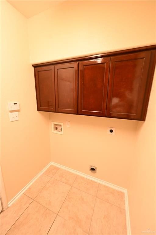 laundry room featuring hookup for an electric dryer, hookup for a washing machine, cabinets, and light tile patterned flooring