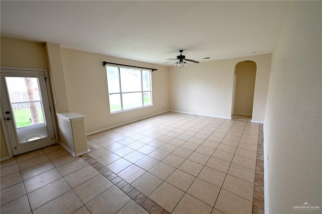 tiled spare room with ceiling fan