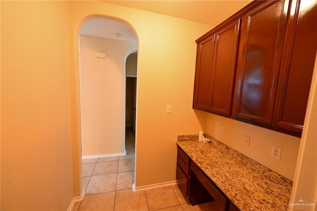 kitchen featuring light stone countertops and light tile patterned floors