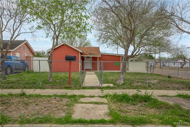 view of yard with a fenced front yard and a gate