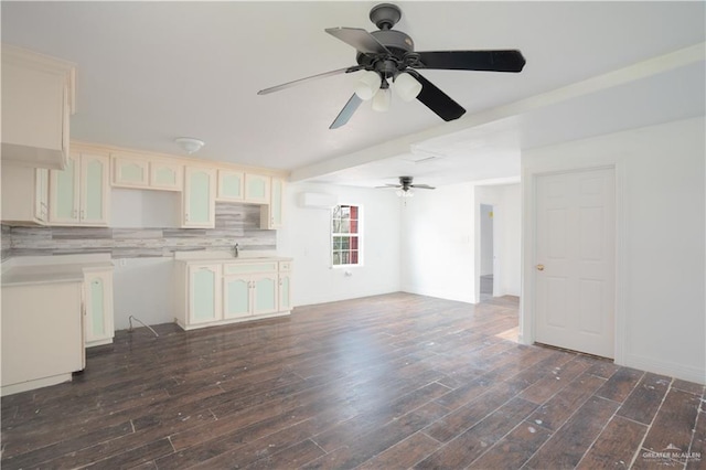 kitchen with dark wood-style floors, light countertops, and tasteful backsplash