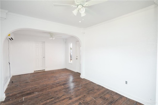 empty room with dark wood-style floors, arched walkways, a wall unit AC, ornamental molding, and a ceiling fan