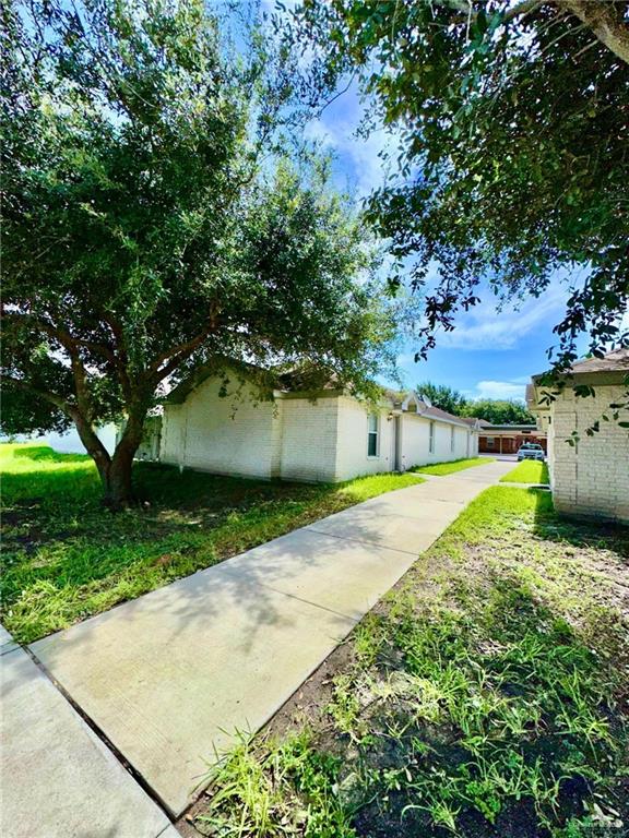 view of side of property with a lawn