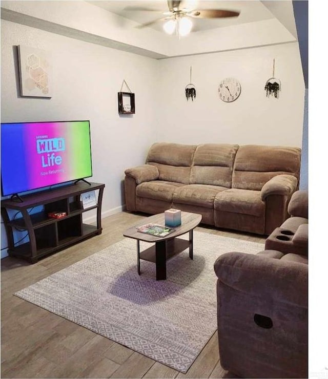 living room with light wood-type flooring and ceiling fan