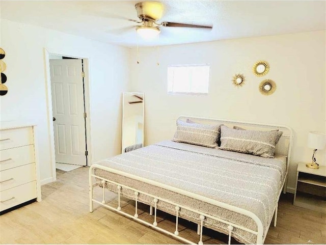 bedroom with ceiling fan and light wood-type flooring