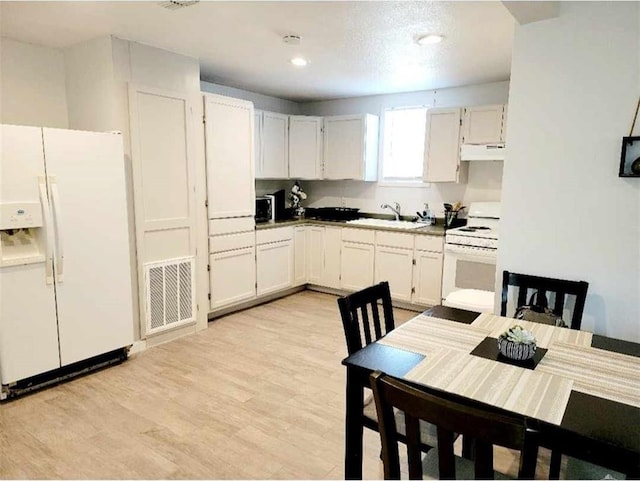 kitchen featuring sink, white cabinets, white appliances, and light hardwood / wood-style flooring