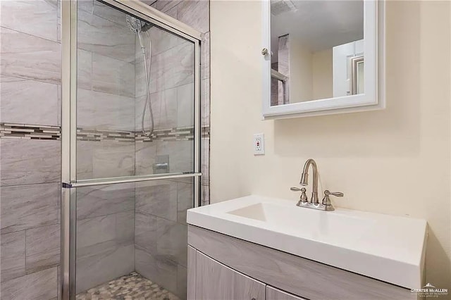 bathroom with vanity and a shower with shower door