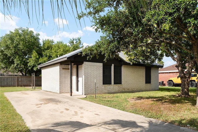 view of property exterior with a lawn