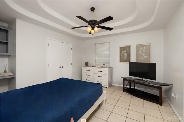 1609 Nassau St, Edinburg, TX 78541 - bedroom featuring a raised ceiling, light tile patterned floors, a ceiling fan, and baseboards