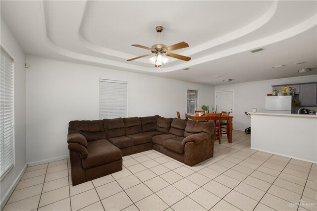 1609 Nassau St, Edinburg, TX 78541 - living room with a raised ceiling, ceiling fan, light tile patterned floors, and baseboards