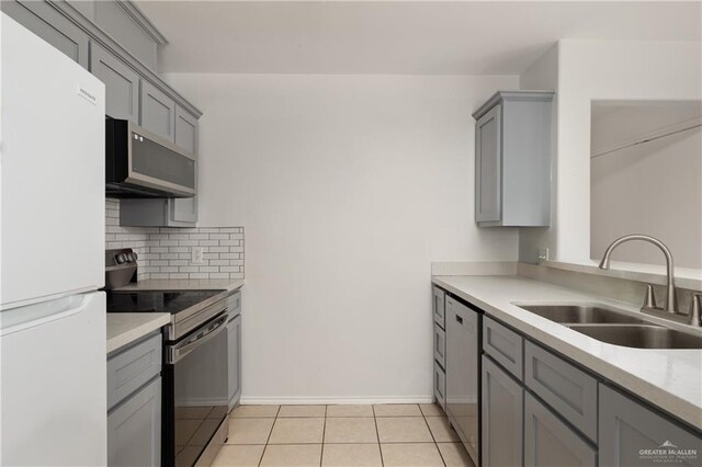 1609 Nassau St, Edinburg, TX 78541 - kitchen featuring appliances with stainless steel finishes, a sink, gray cabinets, backsplash, and light tile patterned flooring