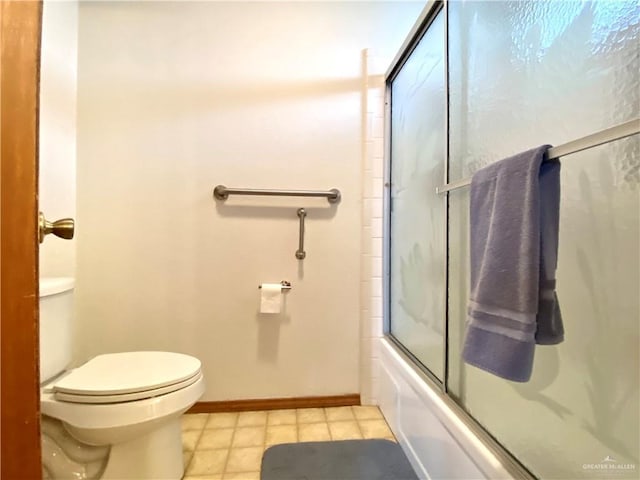 bathroom featuring enclosed tub / shower combo and toilet