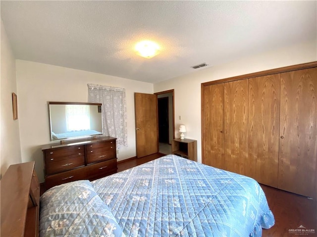 bedroom with a closet and a textured ceiling