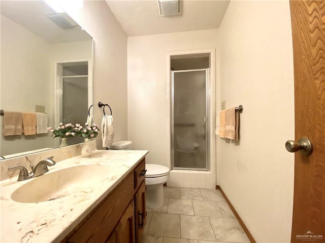 bathroom featuring an enclosed shower, vanity, tile patterned floors, and toilet