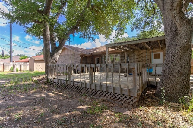 rear view of property featuring a wooden deck