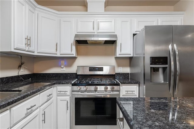 kitchen with white cabinetry, appliances with stainless steel finishes, and dark stone countertops