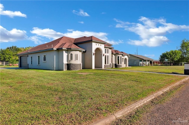 view of side of home featuring a garage and a yard