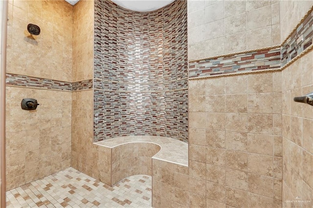 bathroom with tiled shower