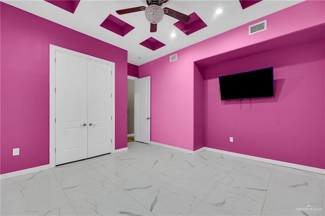 unfurnished bedroom with ceiling fan and a closet