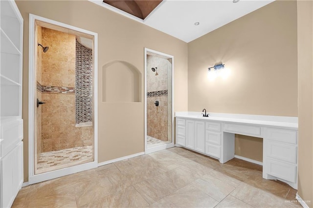 bathroom featuring vanity and a tile shower