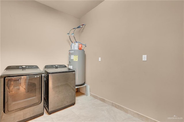 washroom featuring washing machine and dryer and water heater