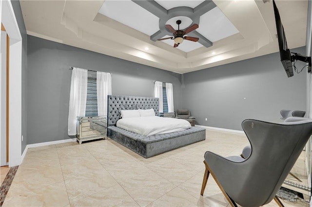 bedroom with a tray ceiling and ceiling fan