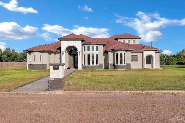 mediterranean / spanish-style home featuring a front lawn