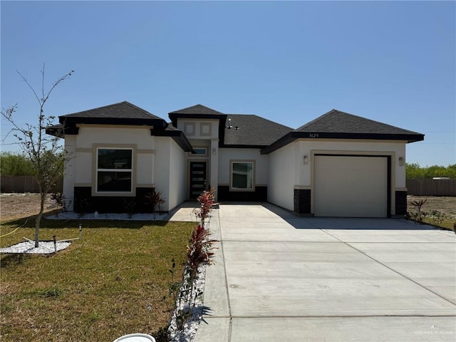 prairie-style house with stucco siding, driveway, a front yard, and a garage