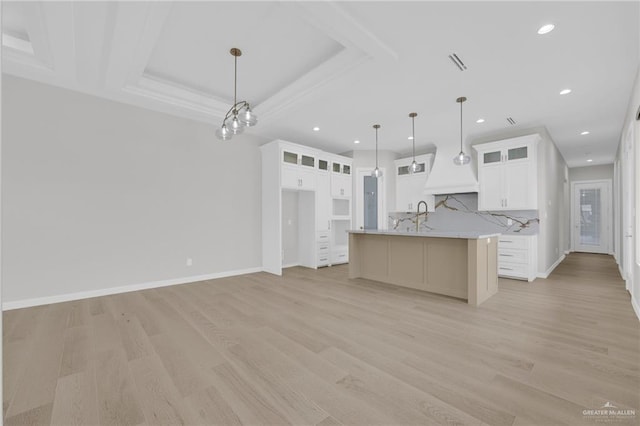 809 Azalea St, Mission, TX 78573 - kitchen with light wood-style flooring, light countertops, a center island with sink, recessed lighting, and white cabinetry