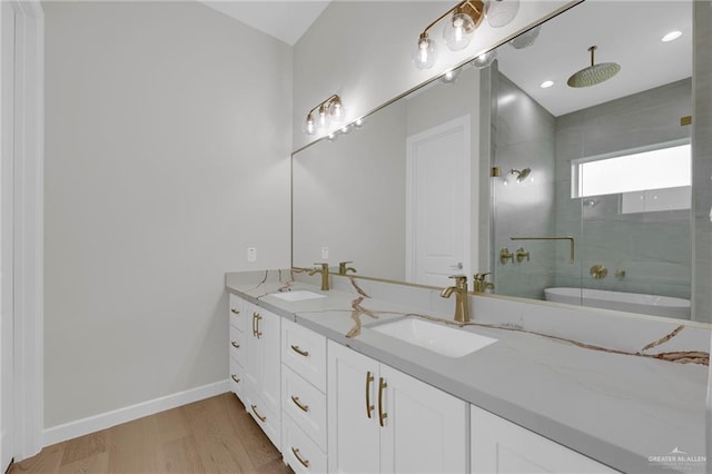 809 Azalea St, Mission, TX 78573 - full bath featuring wood finished floors, a stall shower, double vanity, and baseboards