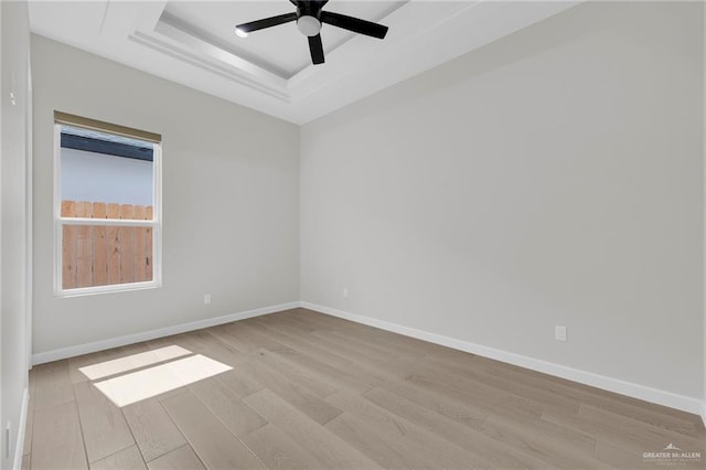 809 Azalea St, Mission, TX 78573 - spare room with a raised ceiling, light wood-type flooring, a ceiling fan, and baseboards