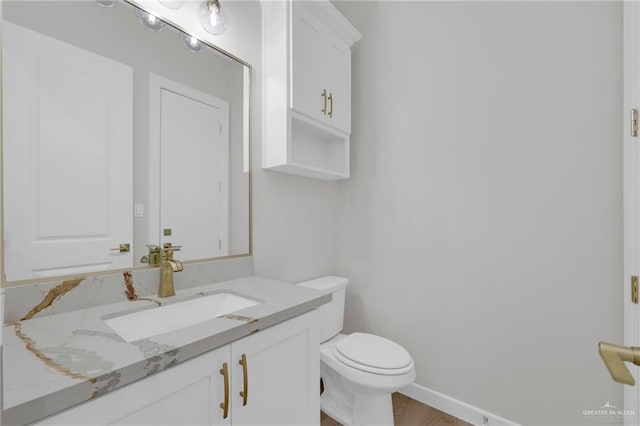 809 Azalea St, Mission, TX 78573 - bathroom featuring toilet, vanity, and wood finished floors