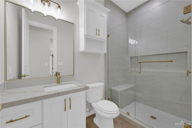 809 Azalea St, Mission, TX 78573 - bathroom with toilet, vanity, a stall shower, and wood finished floors
