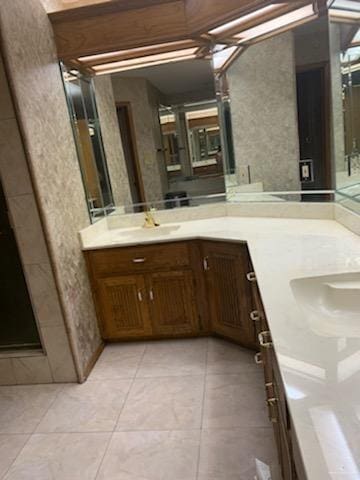 bathroom with tile patterned floors and vanity