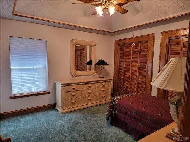 carpeted bedroom featuring ceiling fan and a textured ceiling