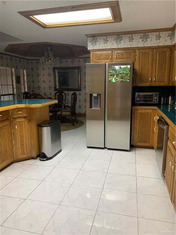 kitchen featuring stainless steel appliances and tile counters