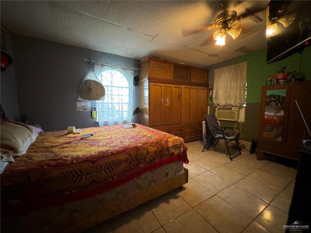 tiled bedroom with ceiling fan and a textured ceiling