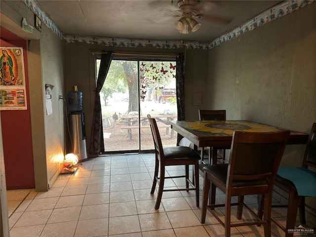 dining space featuring ceiling fan and light tile patterned floors