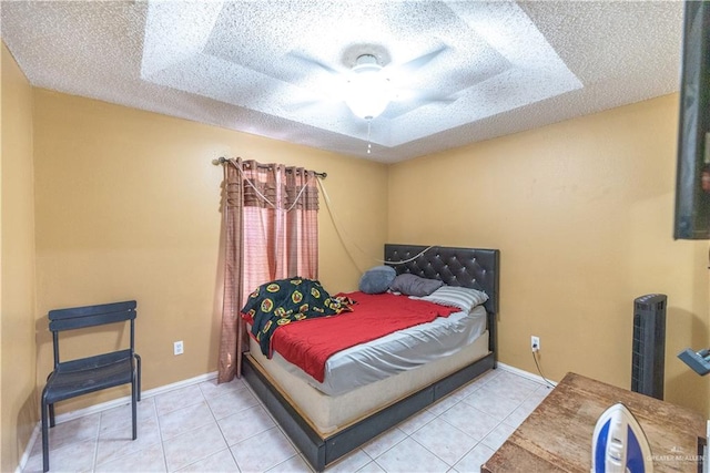 tiled bedroom with ceiling fan and a textured ceiling